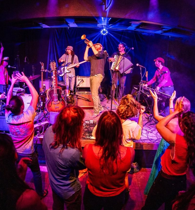Live band and dancing crowd at a Sierra Grass Festival night show